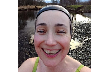 Sarah smiling during a wild swimming session