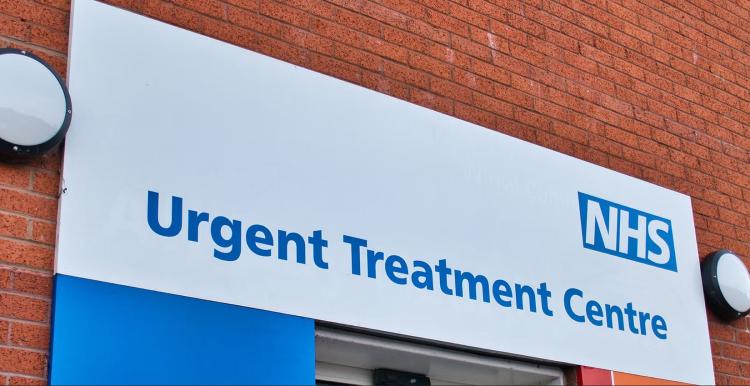 NHS Urgent Treatment Centre signage. NHS logo and blue text on white background.