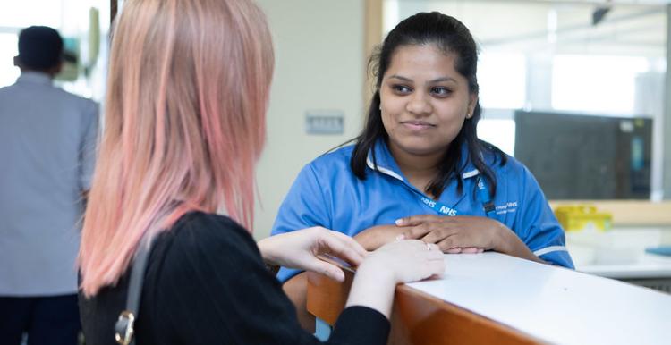 hospital staff talks to member of the public