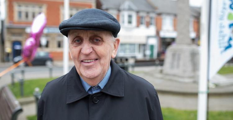 Man in a flat cap standing outside