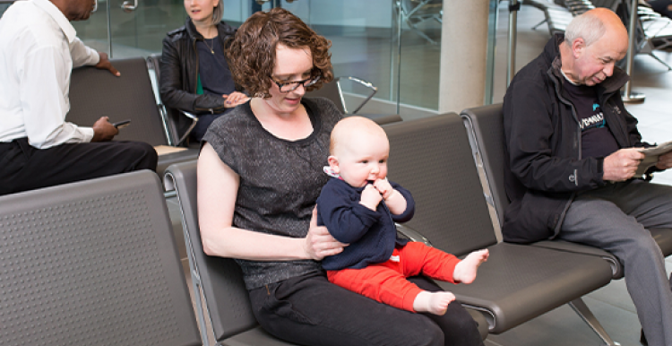 Photograph of people sitting in a health centre waiting area