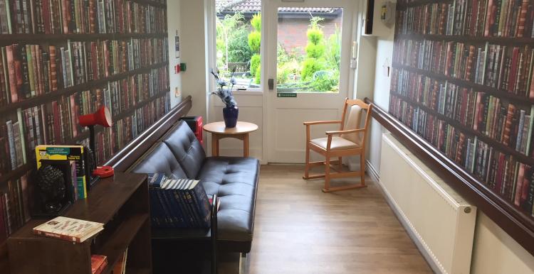 image of an area of a care home decorated as a library