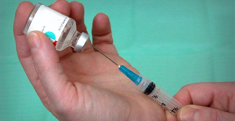 image of needle and vaccine