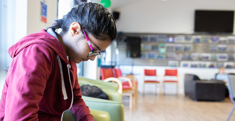 young person looking at their phone