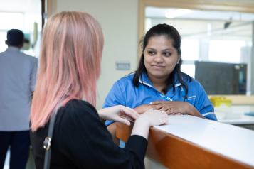 hospital staff talks to member of the public