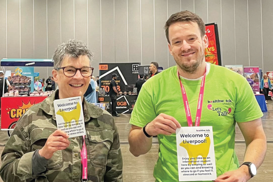 Healthwatch Liverpool staff at event holding leaflets
